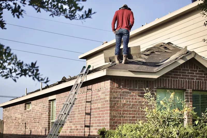 Professional roofer working on a residential roof in Mudlick